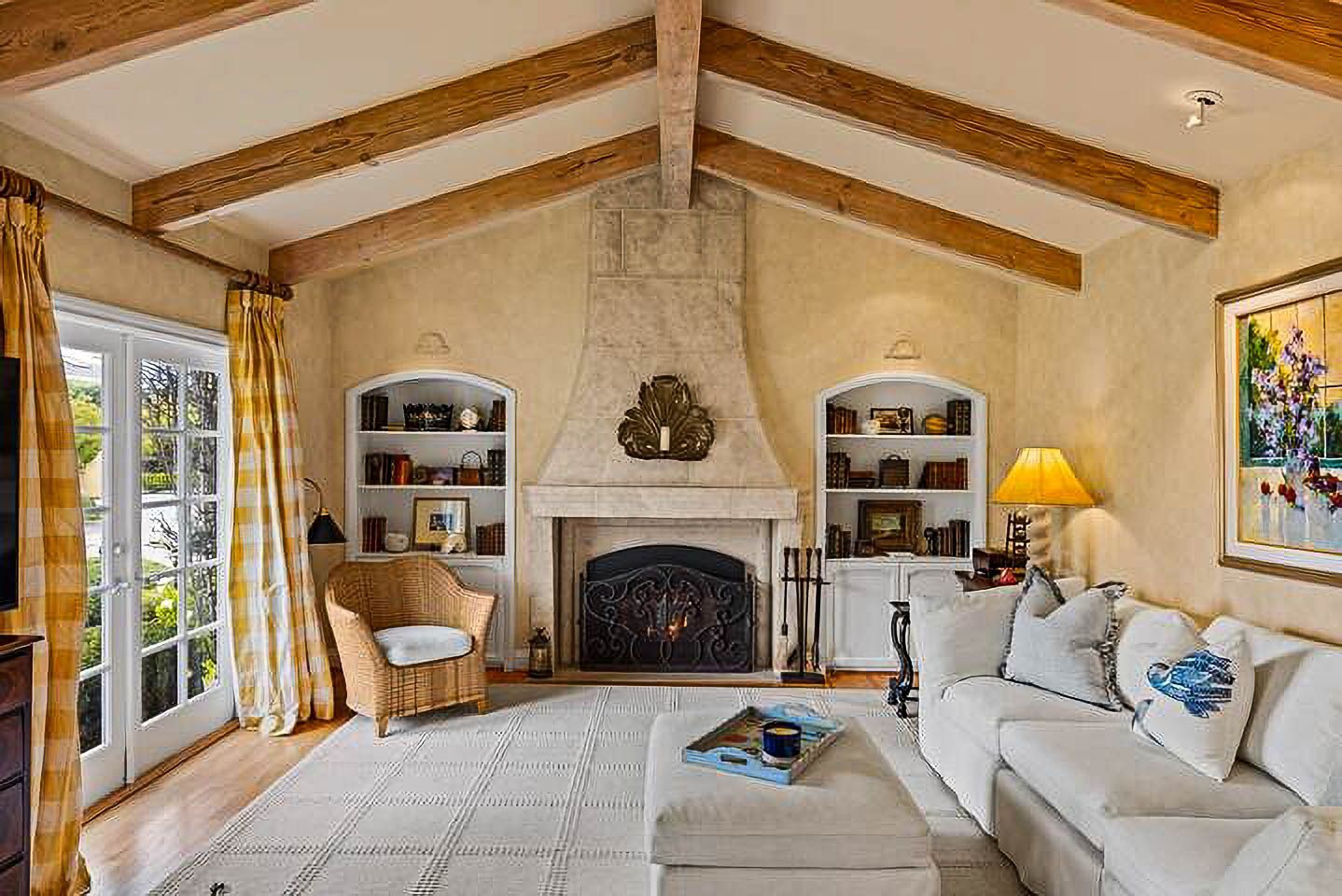 A living room filled with furniture and a fireplace.