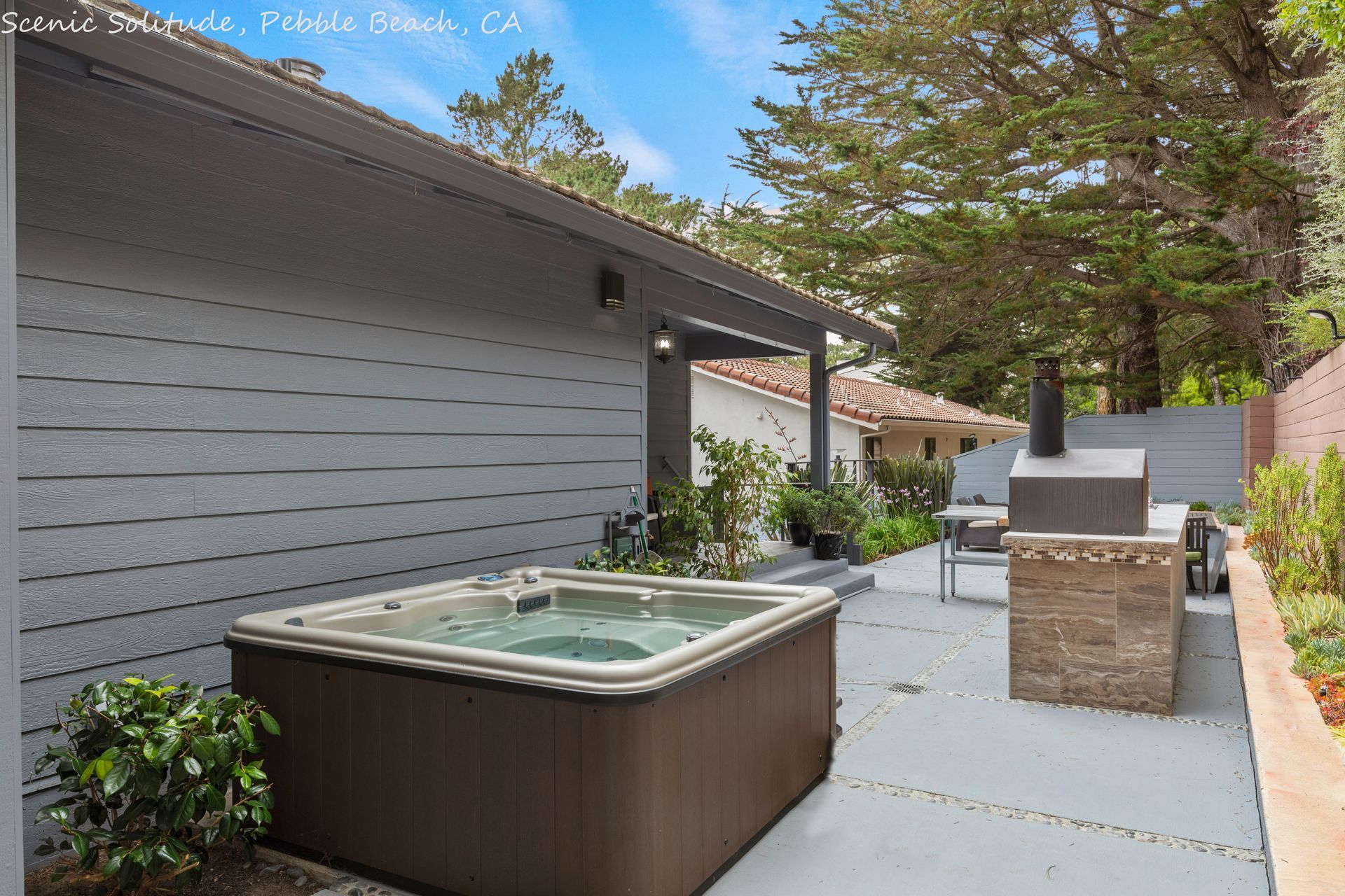 A hot tub is in the backyard of a house