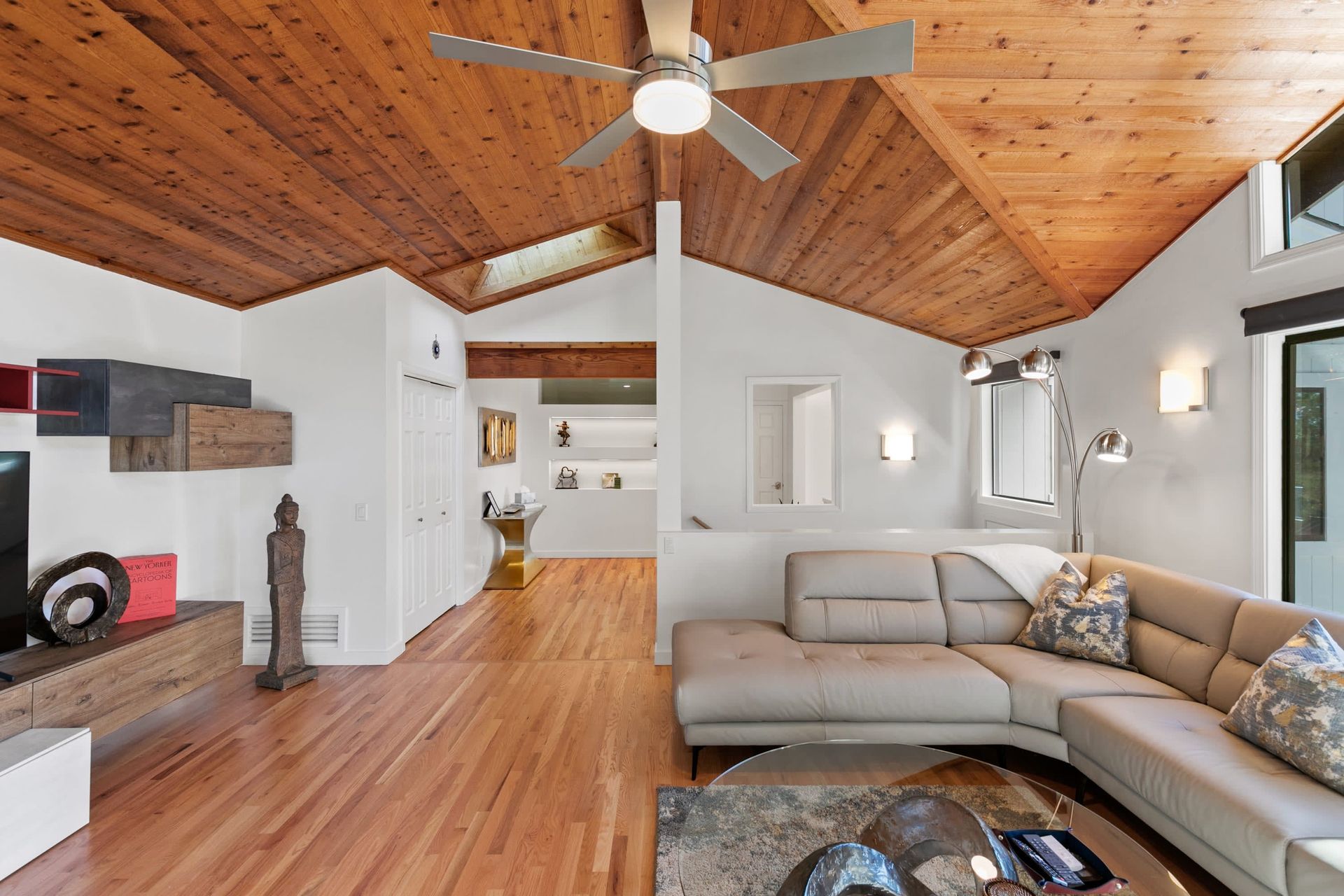 A living room with a couch and a ceiling fan