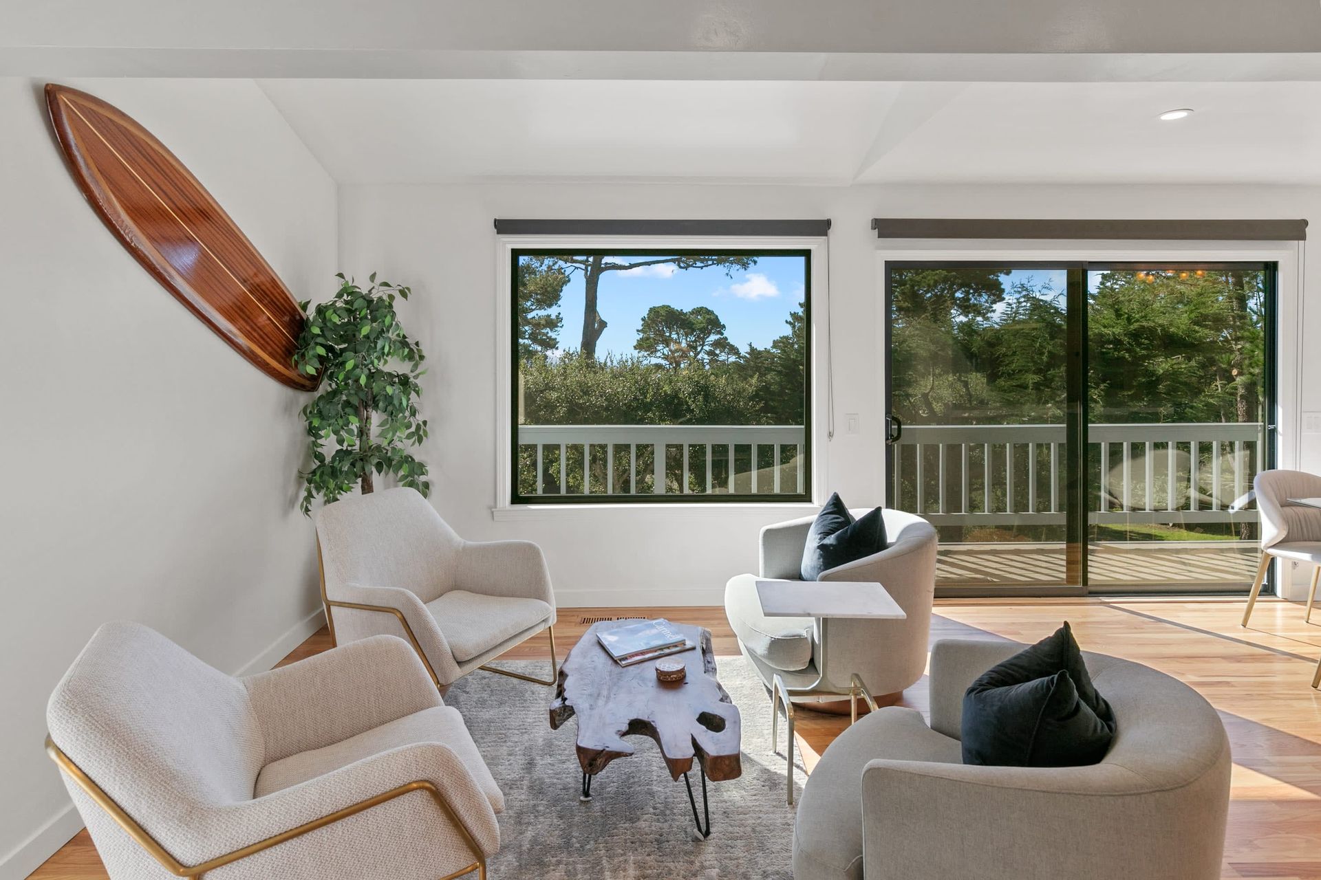 A living room with a surfboard hanging on the wall