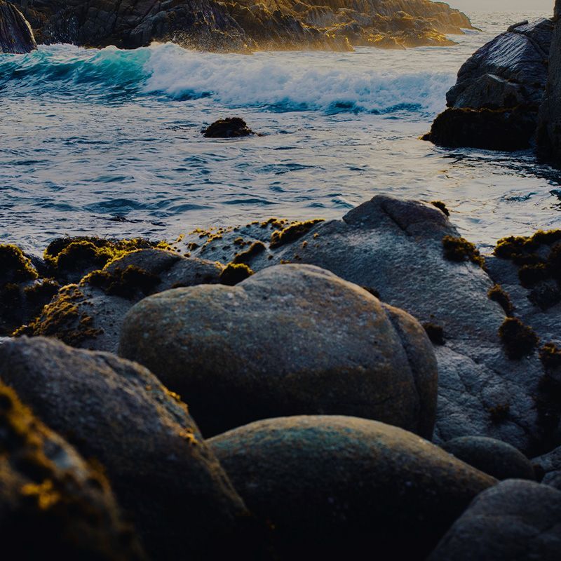 A rocky shoreline with waves crashing on the rocks
