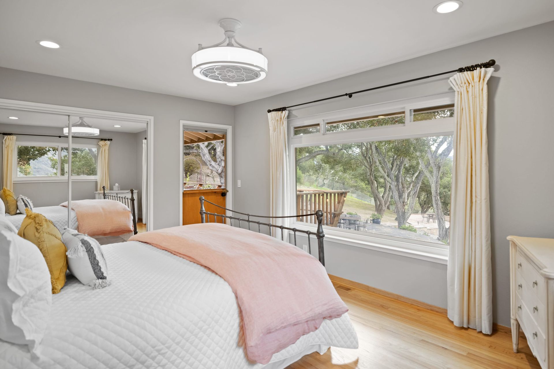 A bedroom with a large bed and a large window.