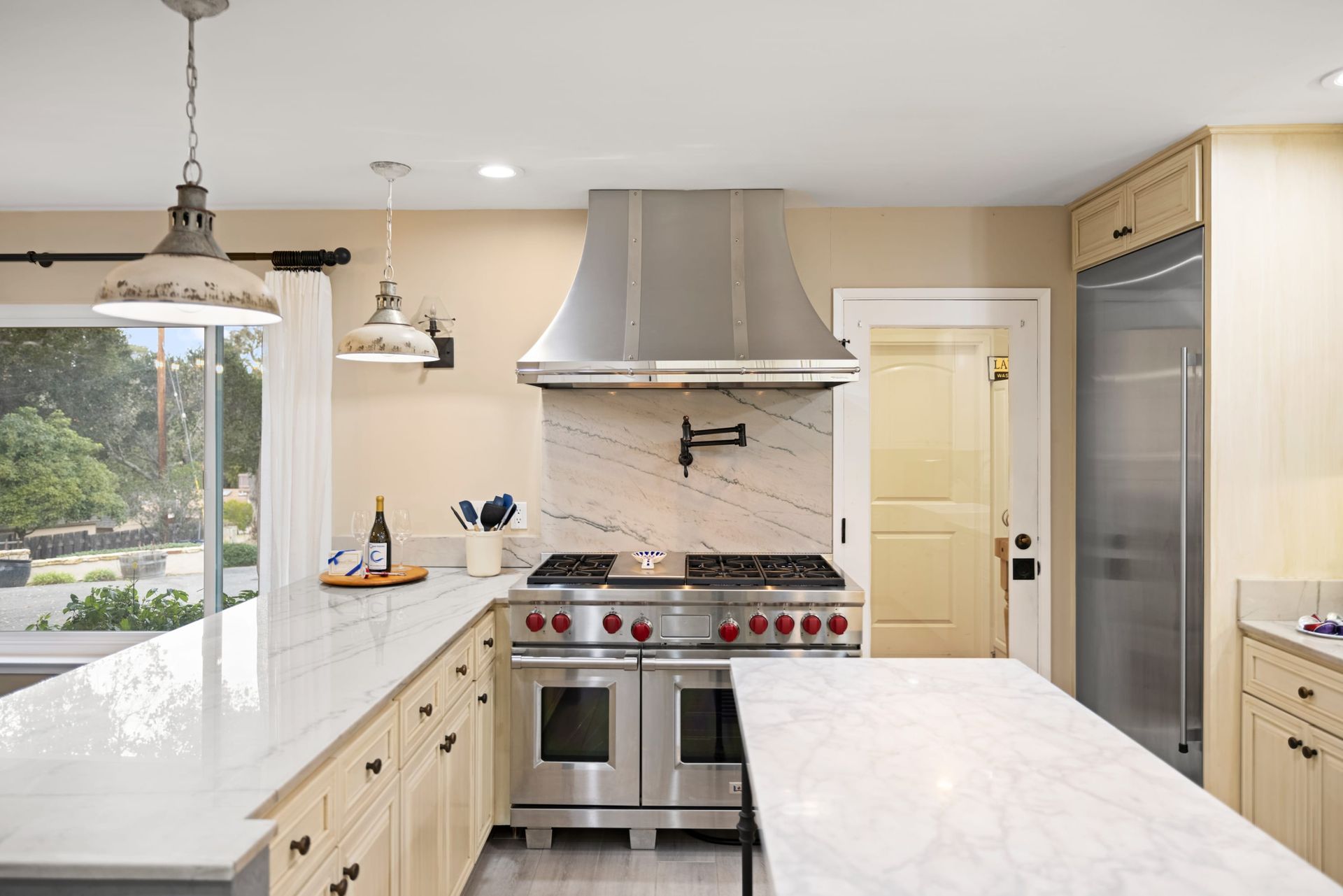 A kitchen with stainless steel appliances and white counter tops