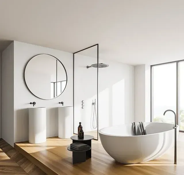 Un baño con bañera y dos lavabos