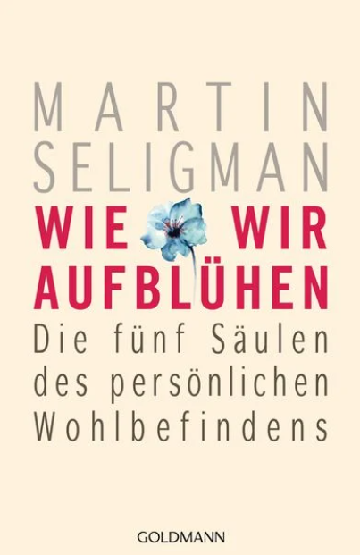 Buchcover: „Wie wir aufblühen“ von Martin Seligman, mit blauer Blumengrafik und Text auf hellem Hintergrund.