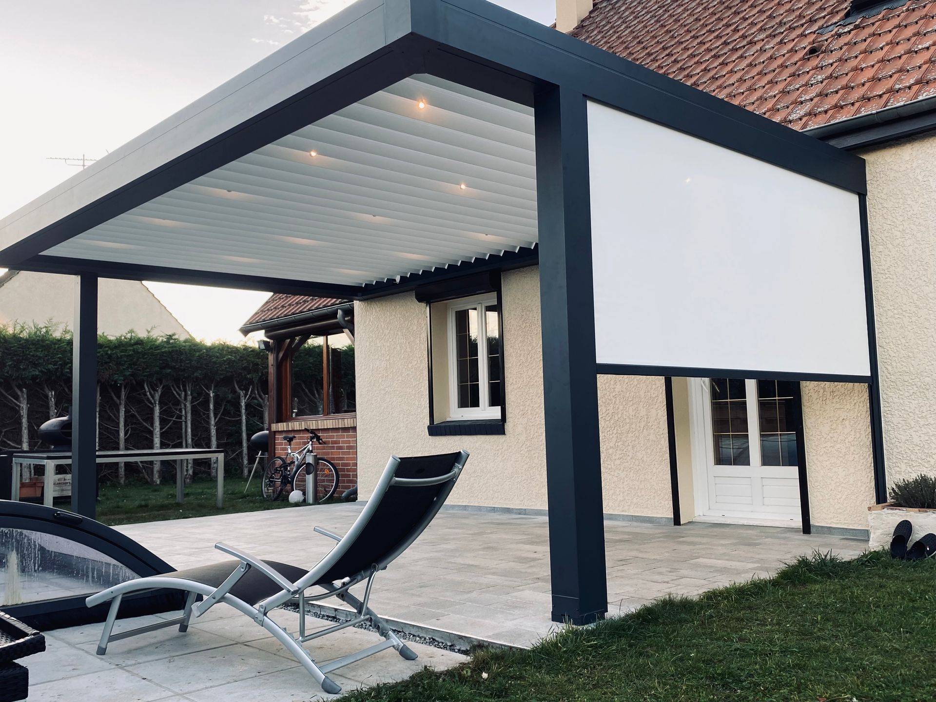 Pergola avec des stores et lames orientables.