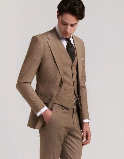 Una persona vestida con un traje de tres piezas marrón 