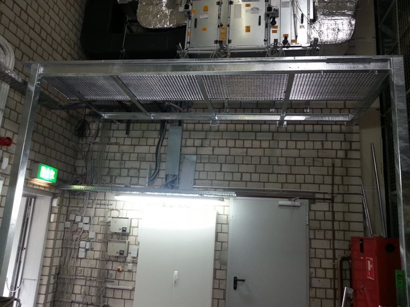 Ein Raum mit einer Ziegelwand und einem Metallregal darauf.