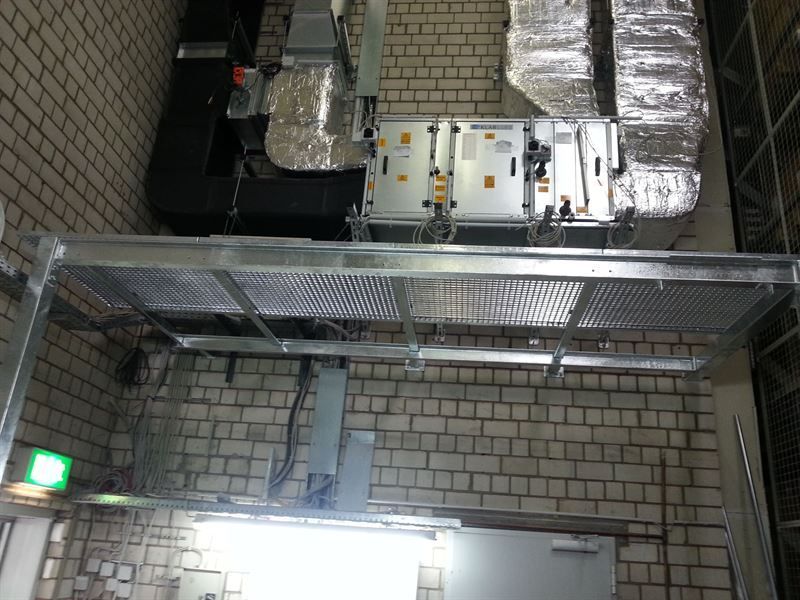 Ein Raum mit vielen von der Decke hängenden Leitungen.