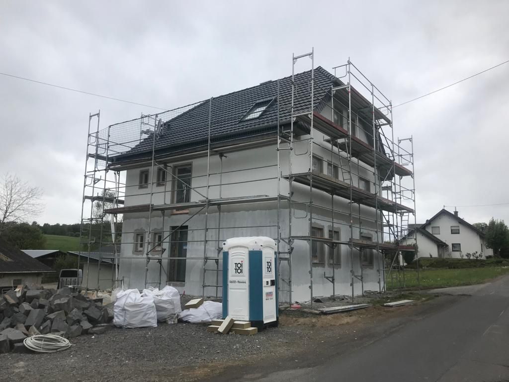 Es wird ein Haus mit Gerüst darum herum gebaut.