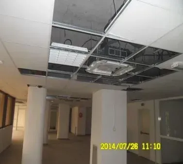 An empty hallway with a ceiling that is missing 