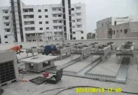 A man is working on the roof of a building.