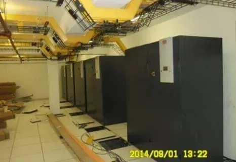 A row of servers are being installed in a data center.