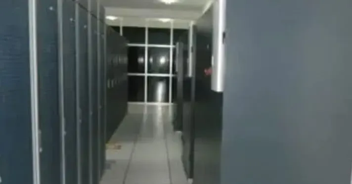 A long hallway filled with lockers and a window.