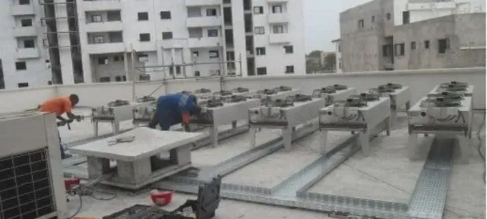 A man is working on the roof of a building.
