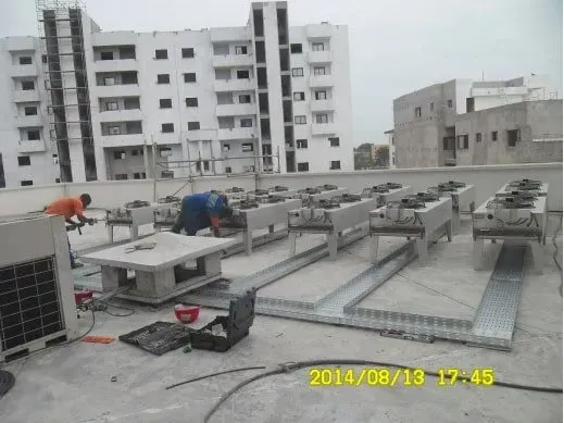 A man is working on the roof of a building.
