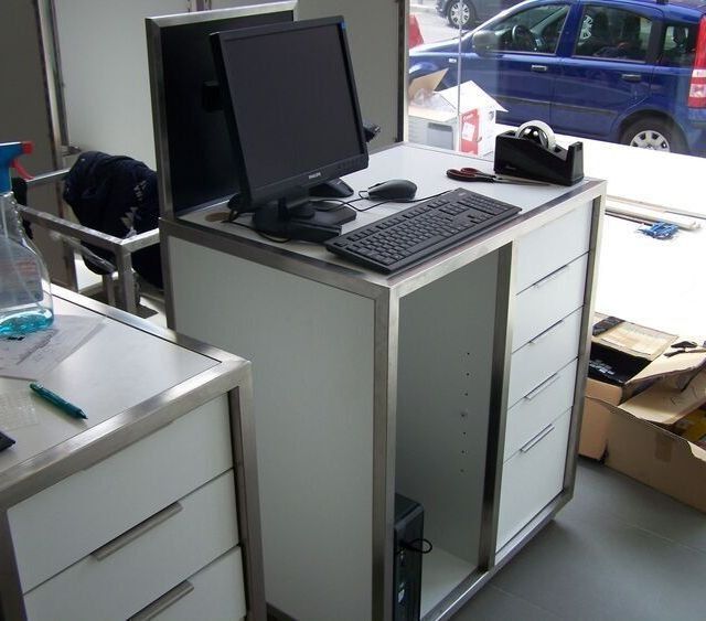 Un escritorio con un monitor de computadora y un teclado encima.