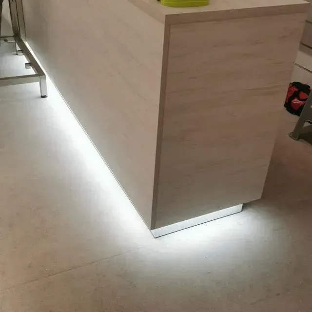 Un mostrador blanco con una luz debajo.