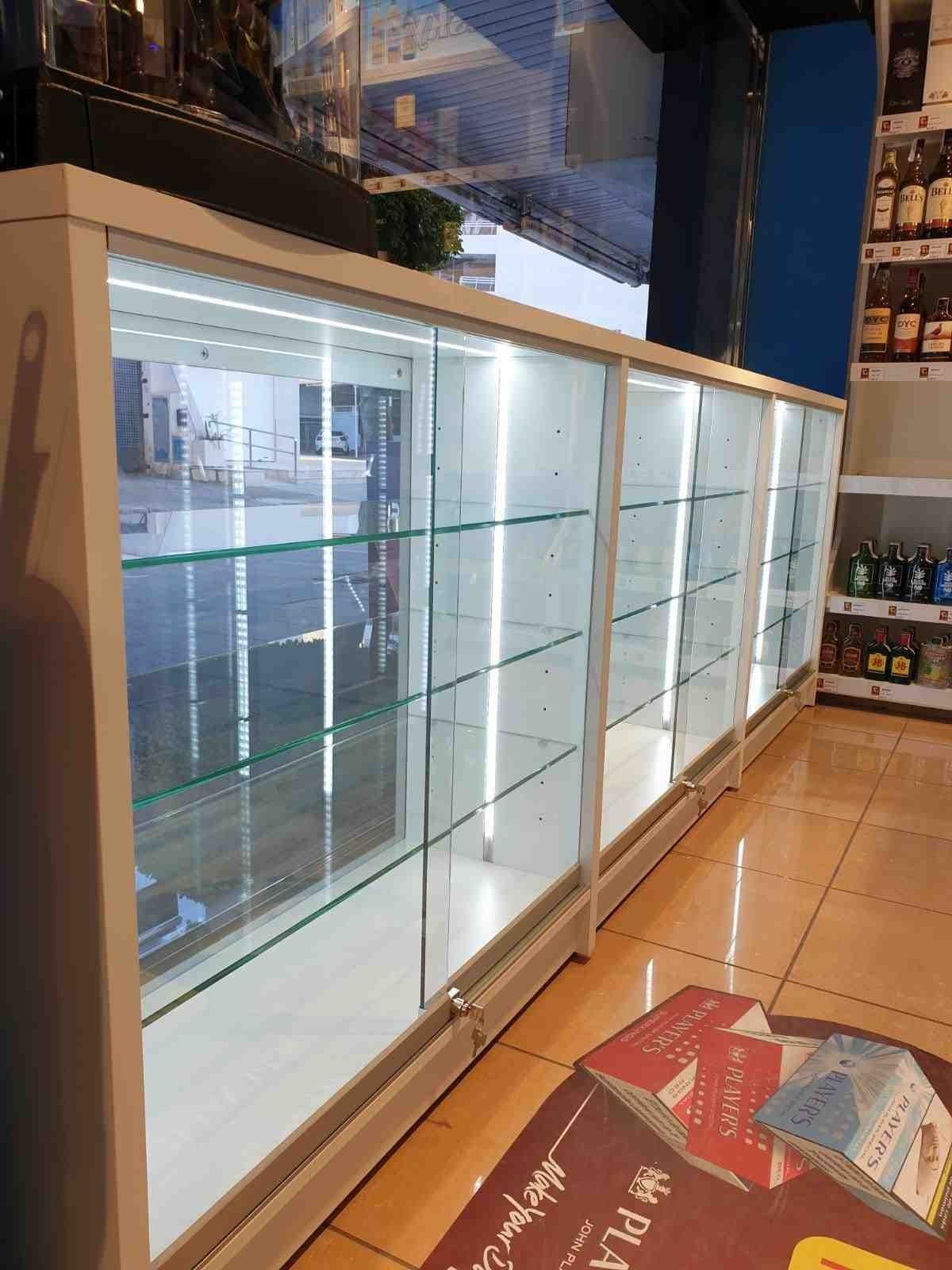 Una fila de estantes de vidrio en una tienda.