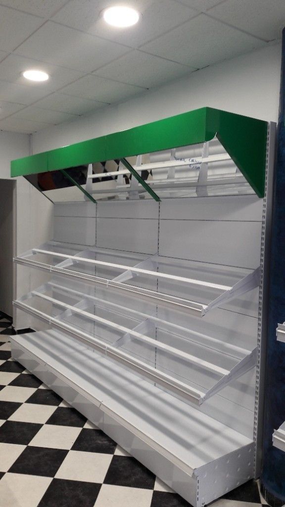 Un estante de tienda vacío con un techo verde y un suelo a cuadros.