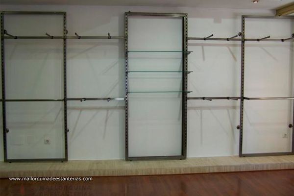 Una fila de percheros están alineados contra una pared blanca