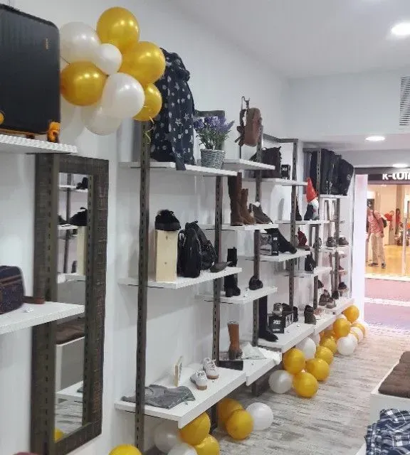 Una tienda con estantes llenos de zapatos y globos