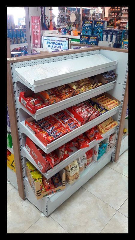 Un estante de tienda lleno de muchos bocadillos y dulces.