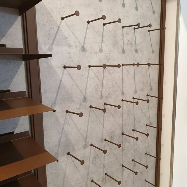 Una pared con un montón de clavos en ella