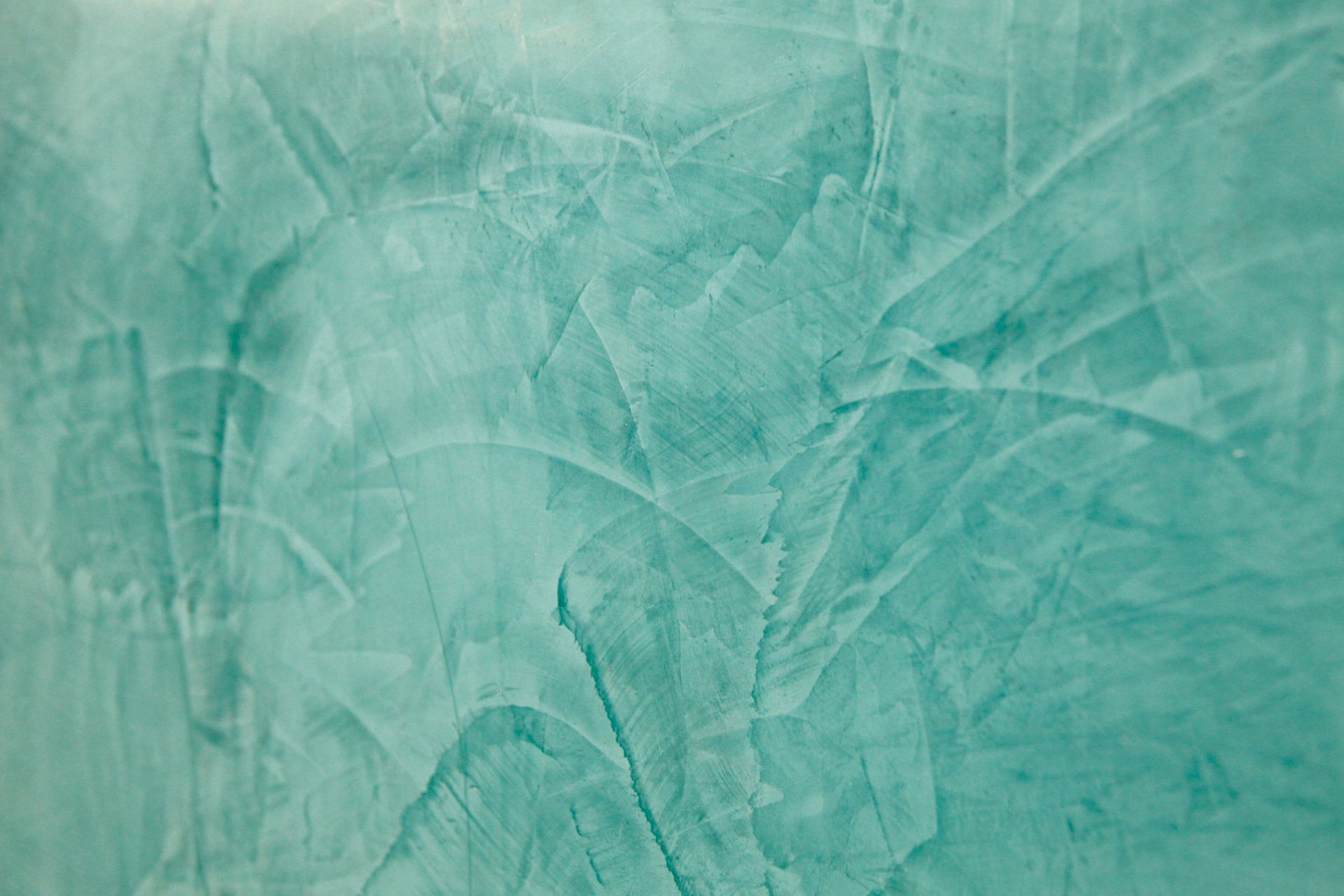 Eine Nahaufnahme einer grünen Wand mit einer Textur.