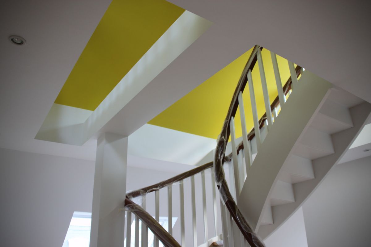 Eine Treppe mit einem gelben Streifen an der Decke