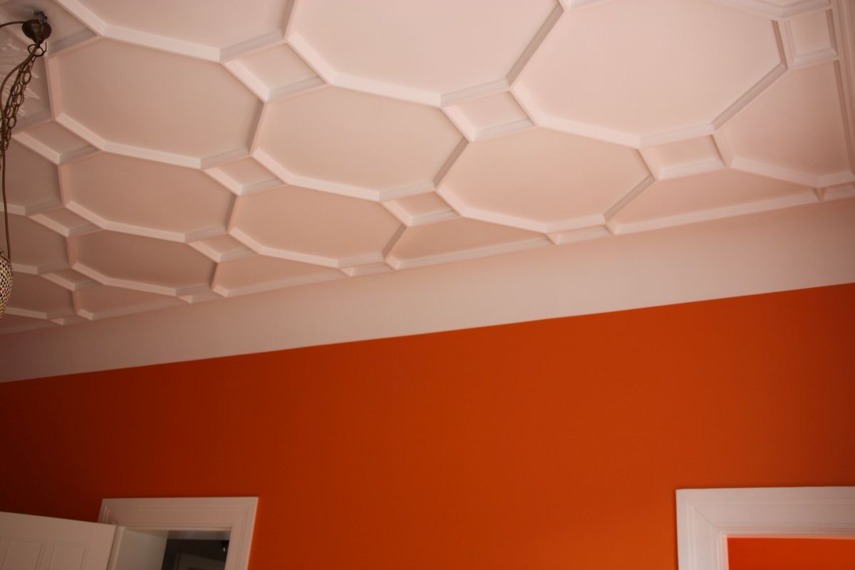 Ein Raum mit orangefarbenen Wänden und einer weißen Decke