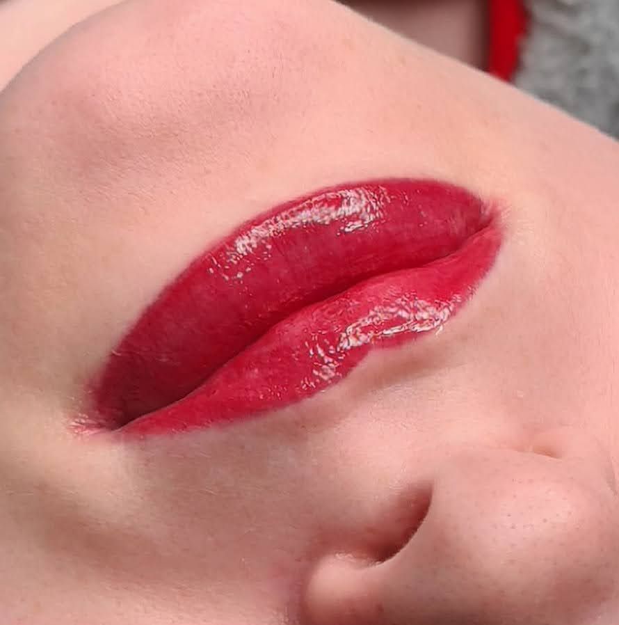 Eine Nahaufnahme der Lippen einer Frau mit rotem Lippenstift.