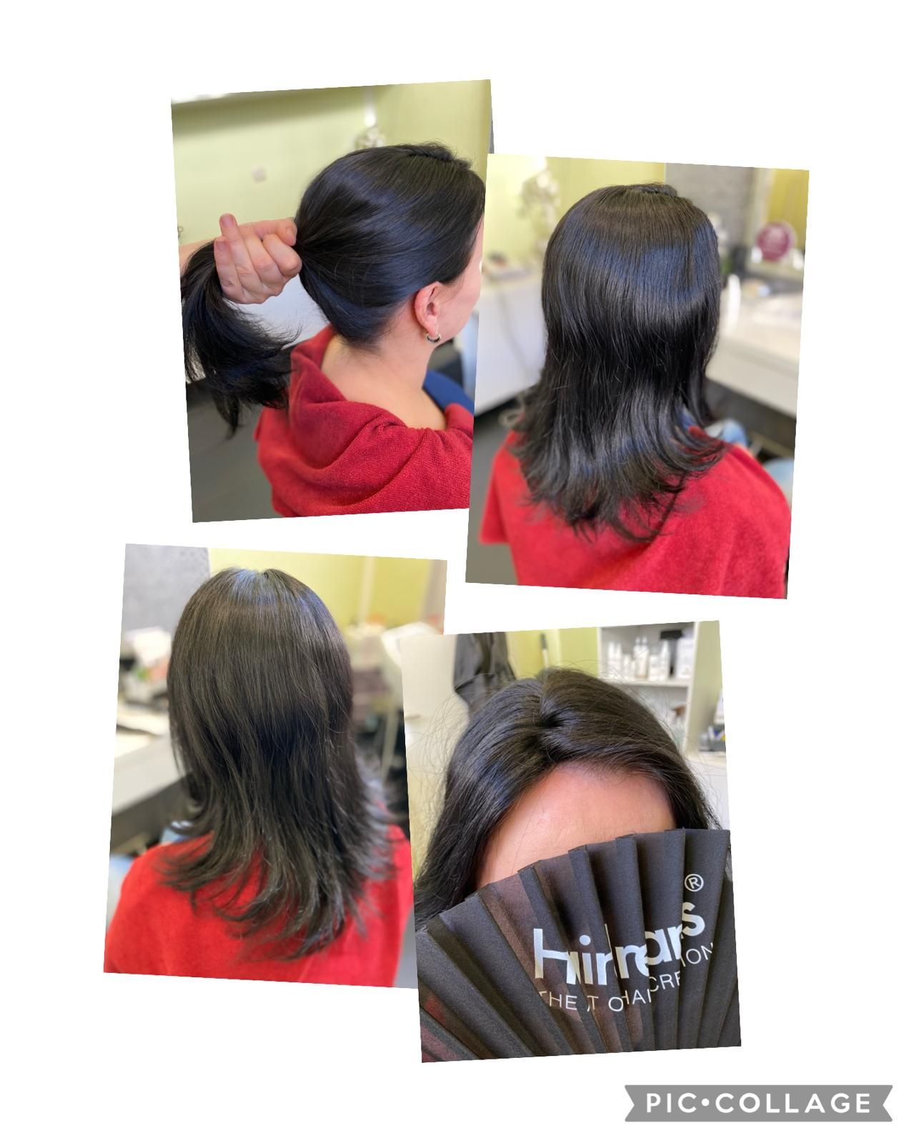 Frau mit dunklem Haar im Friseursalon. Ihr Haar wird gestylt und anhand einer Farbprobe gezeigt.