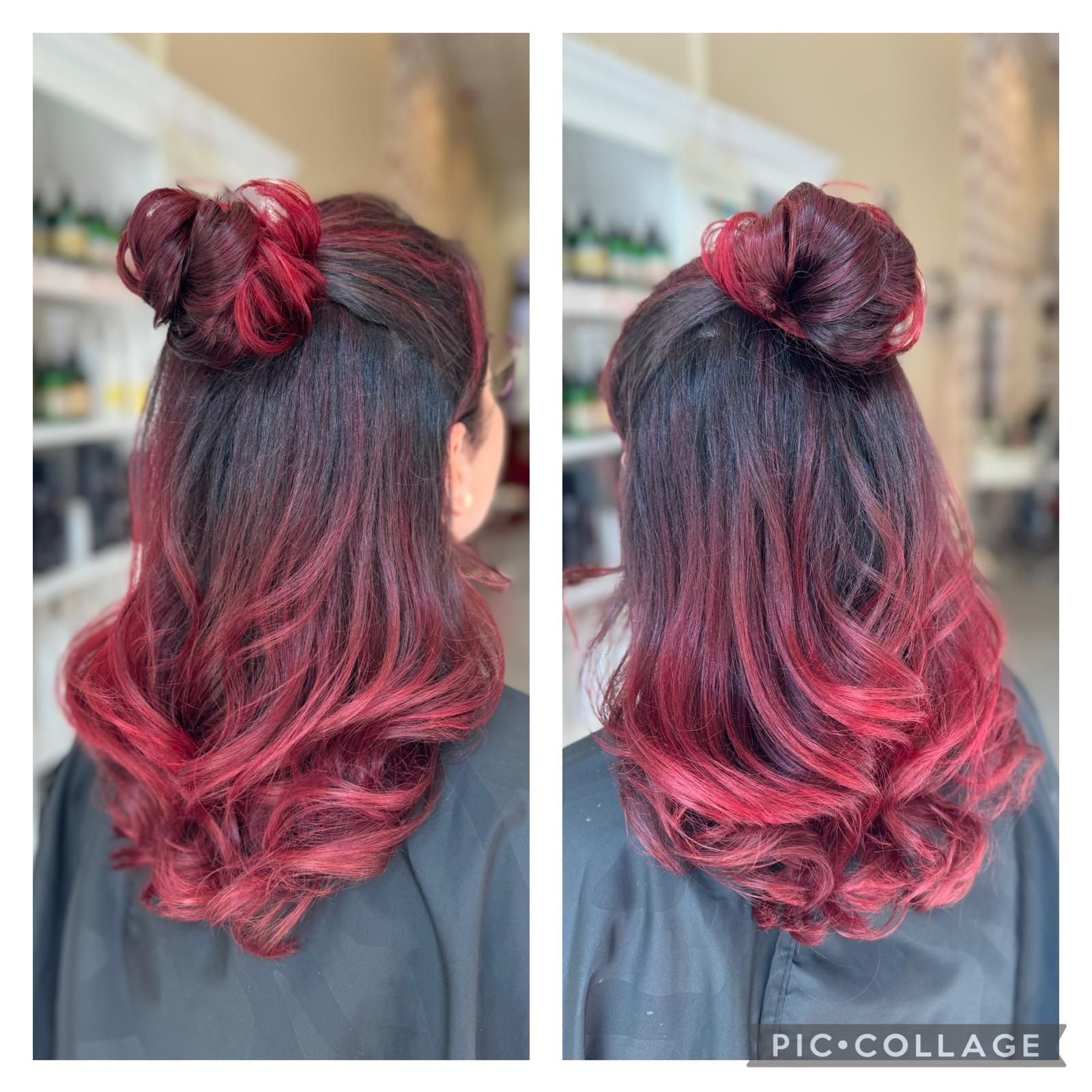 Die dunkle Haarpracht der Frau ist mit einem roten Ombré-Effekt und einem hohen Dutt gestylt.