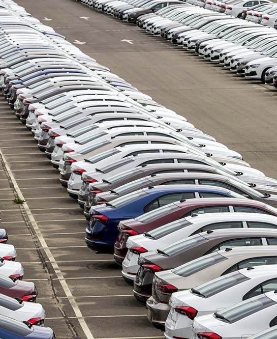 Hay muchos coches aparcados en un estacionamiento.