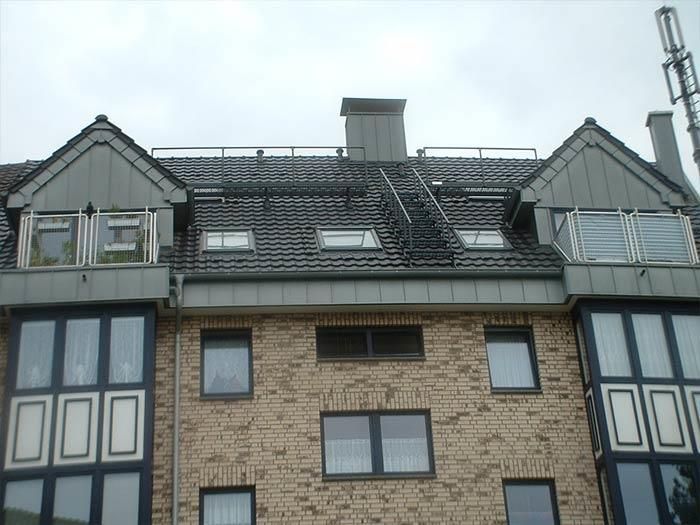 Ein Backsteingebäude mit einem Balkon auf dem Dach