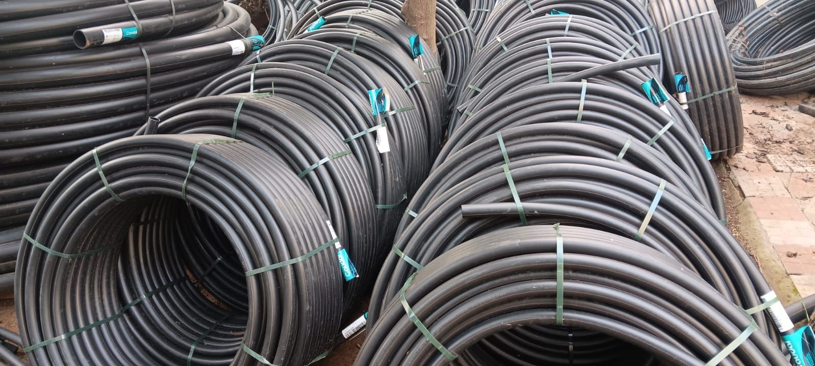 Un montón de tubos negros están apilados uno encima del otro.