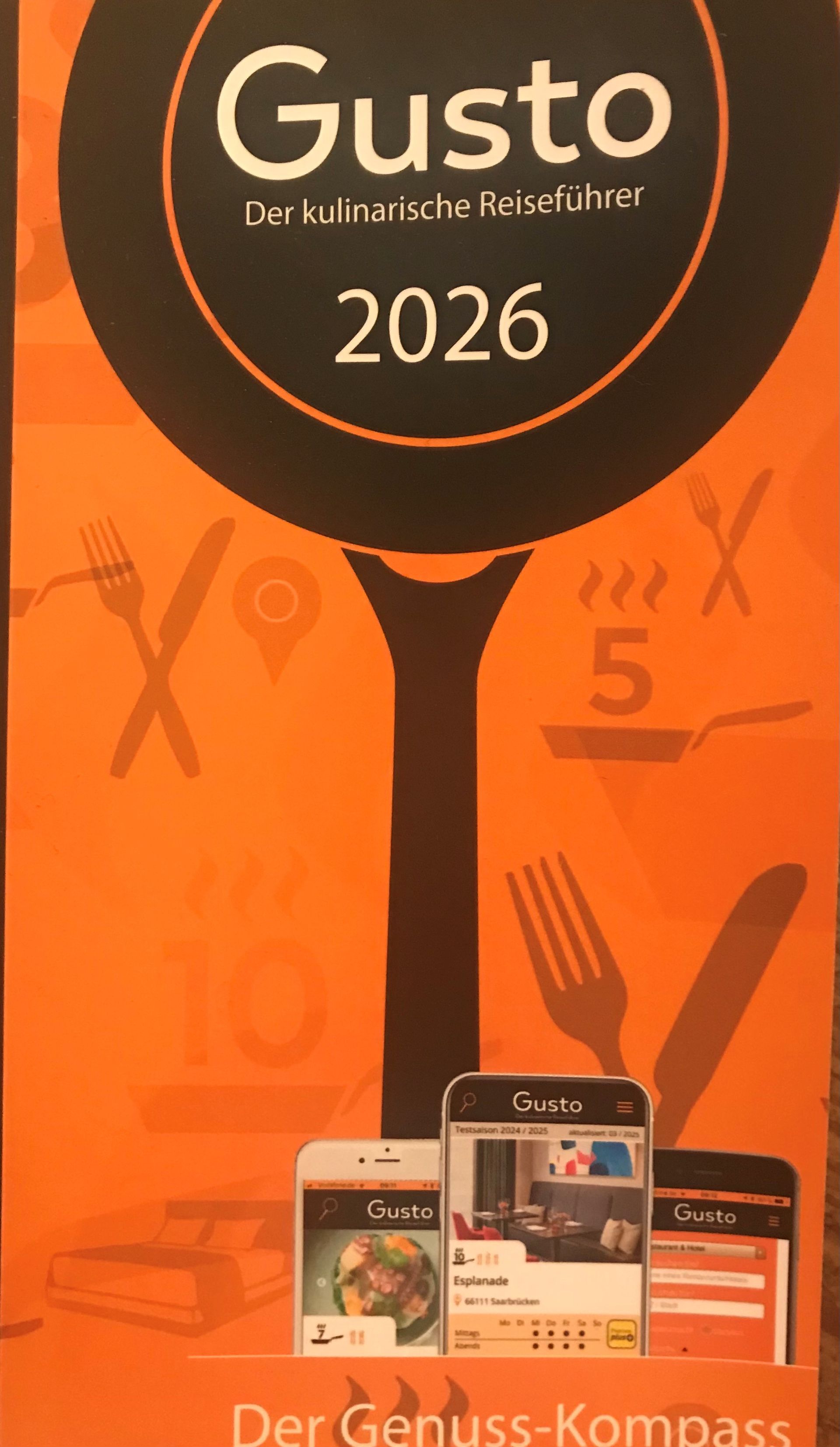 Gusto-Food-Guide-Poster in Orange und Schwarz für 2026.