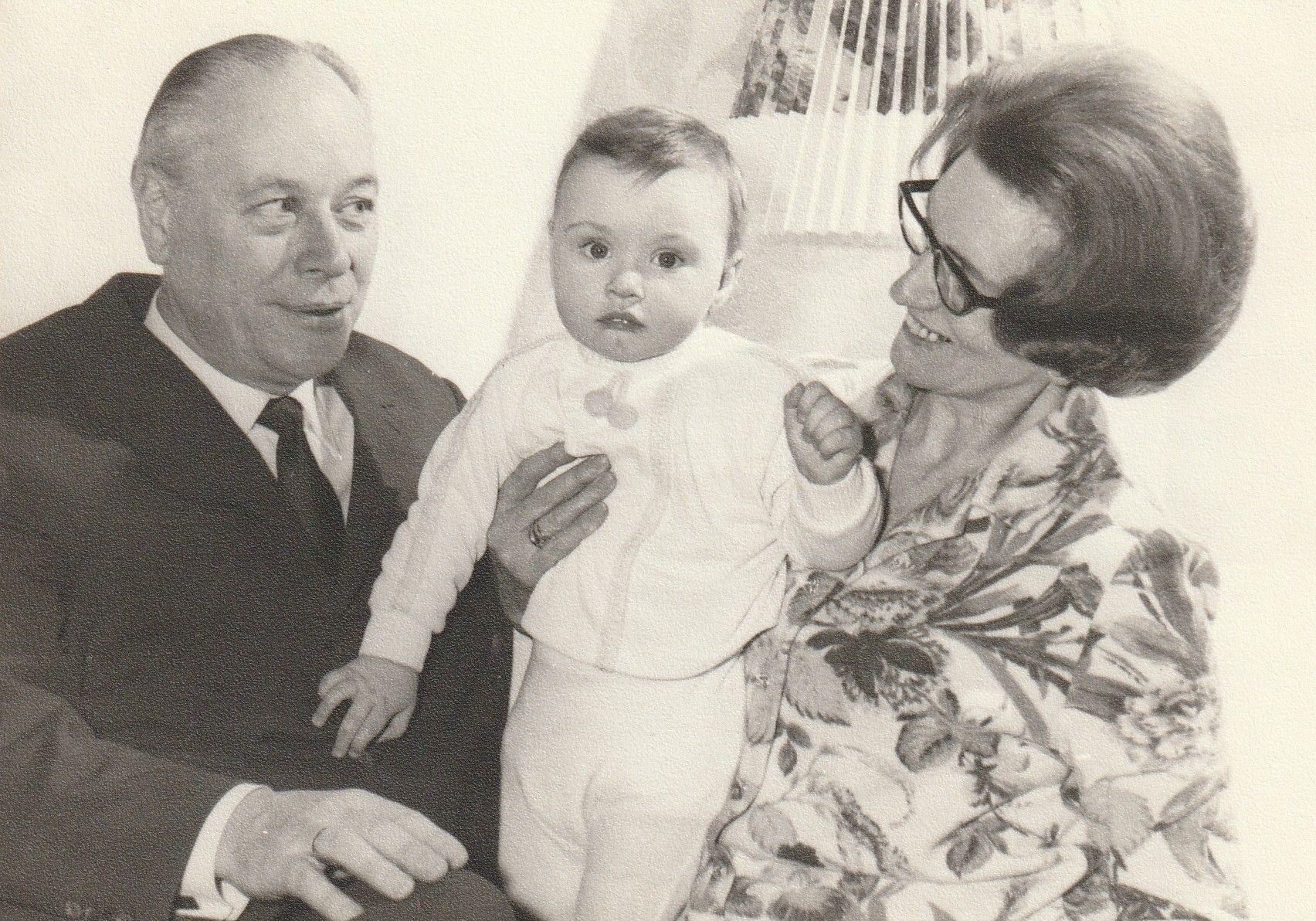 Ein Schwarzweißfoto von einem Mann und einer Frau, die ein Baby halten