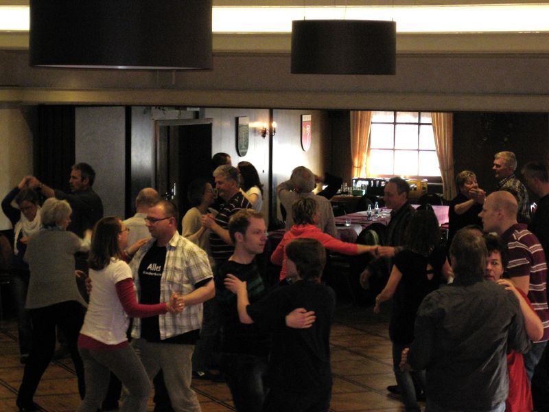 Eine große Gruppe von Menschen tanzt in einem Raum