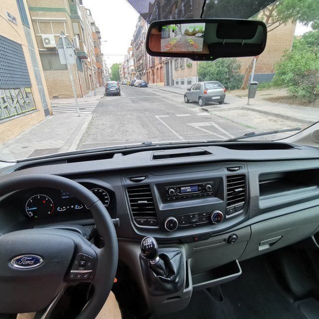 El interior de un coche Ford con volante y tablero.