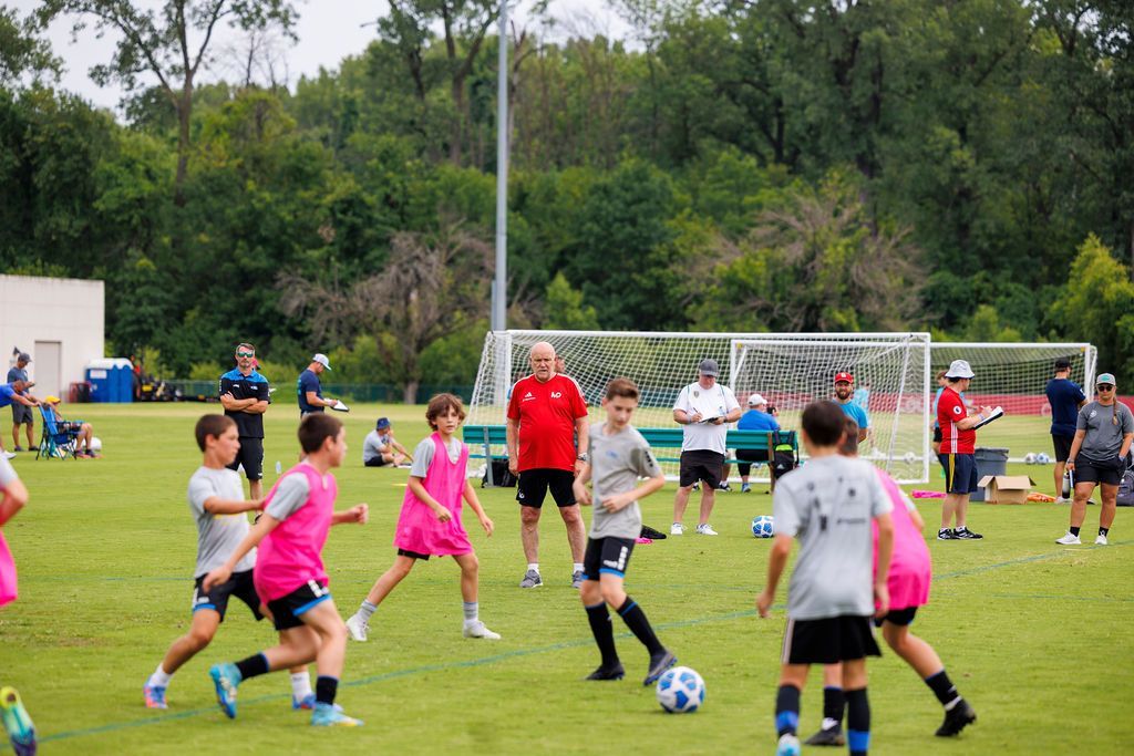 A group of children are playing soccer on a field