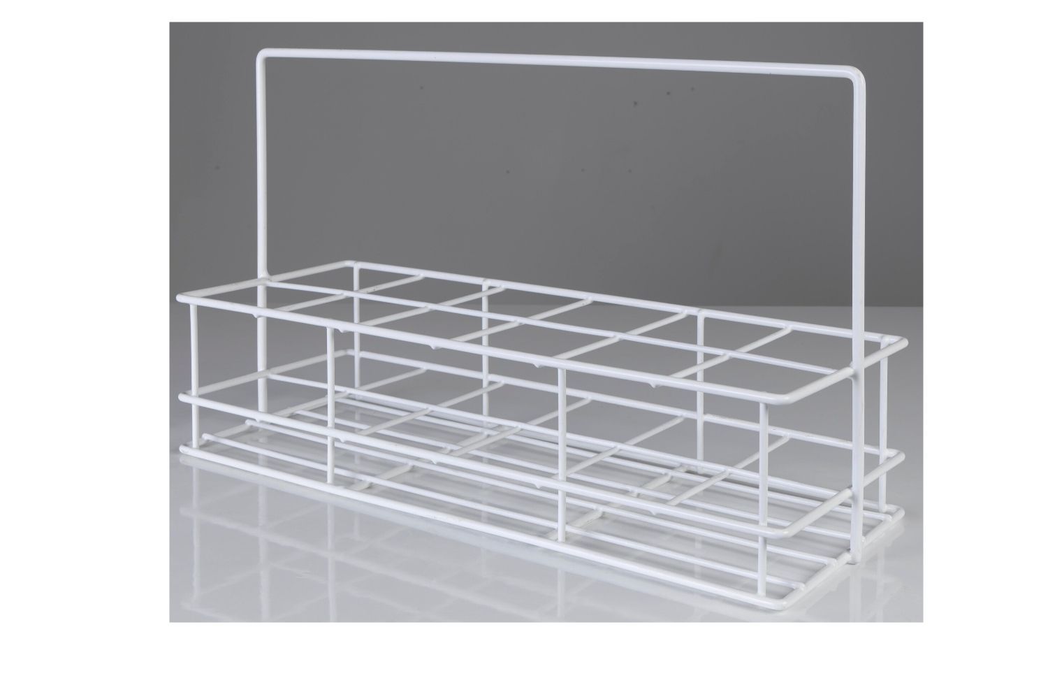 A white wire basket with a handle is sitting on a table.