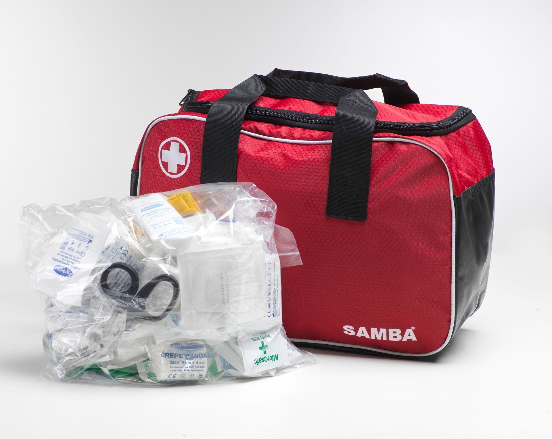 A red and black samba bag filled with medical supplies