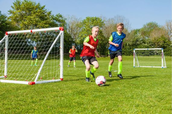 A soccer goal with a ball and hoops attached to it