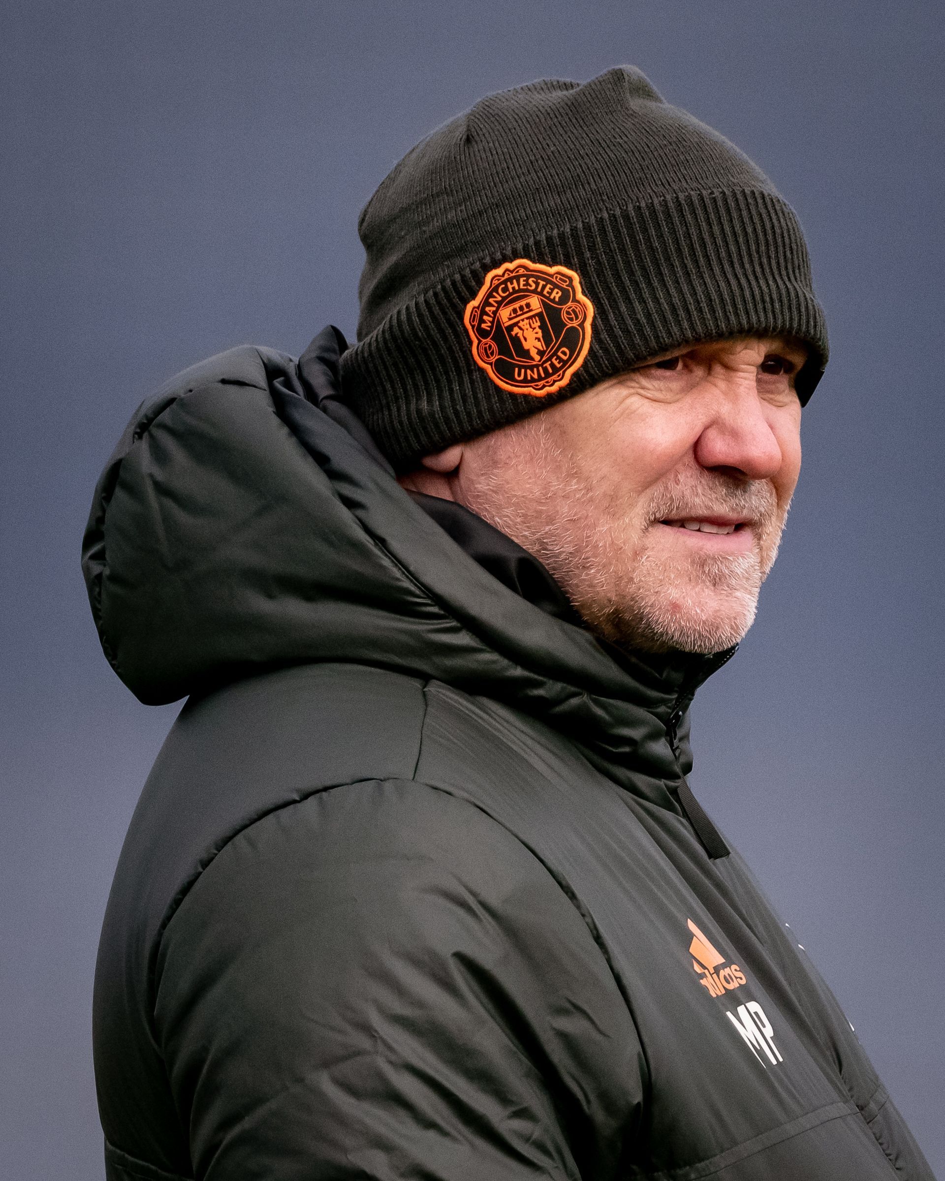 A man with a beard wearing a beanie and a jacket