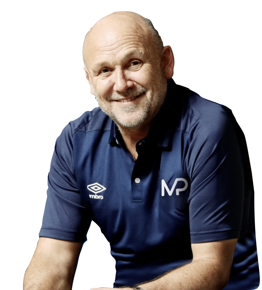 A man wearing a blue umbro polo shirt is smiling