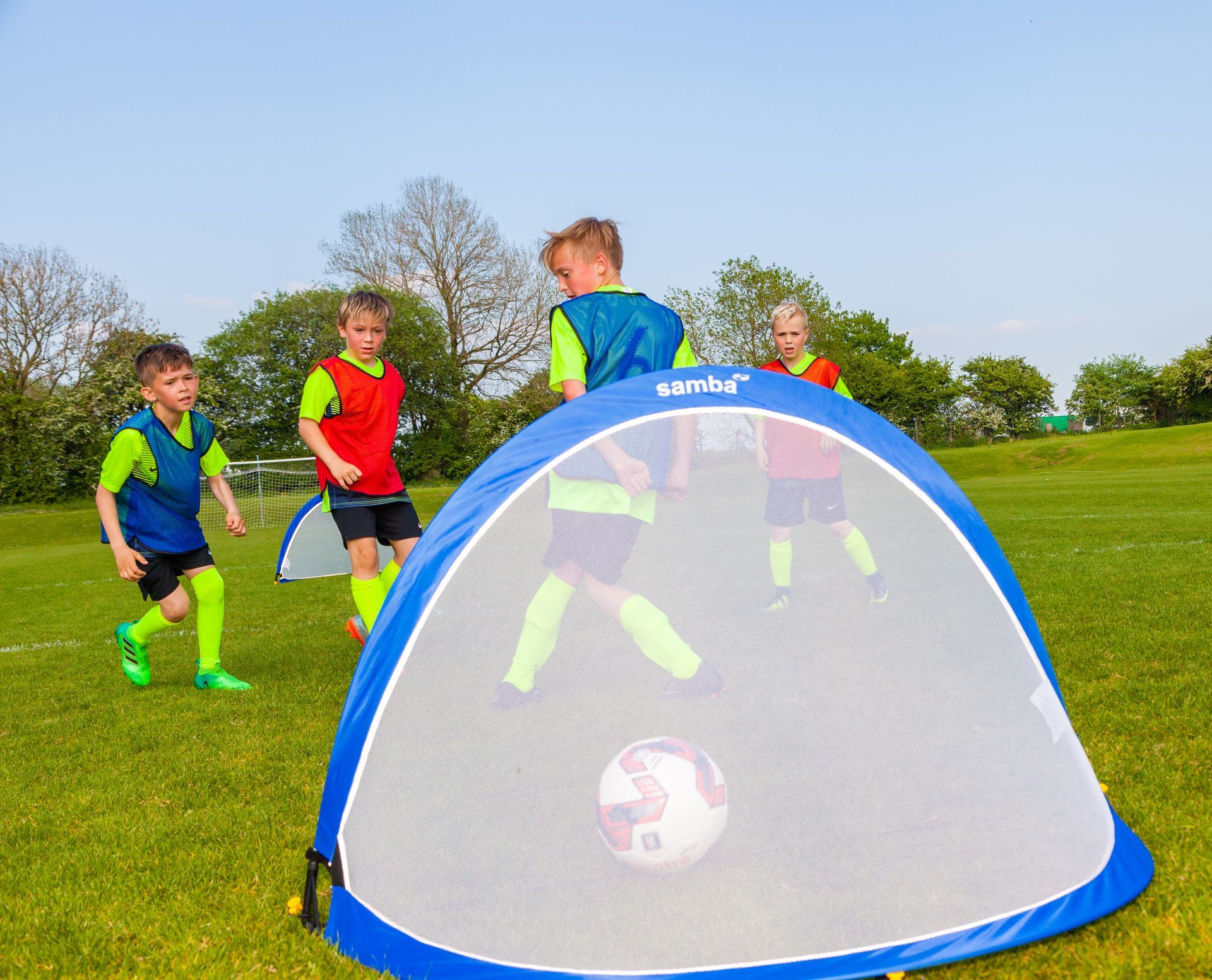 A group of young boys are playing soccer on a field