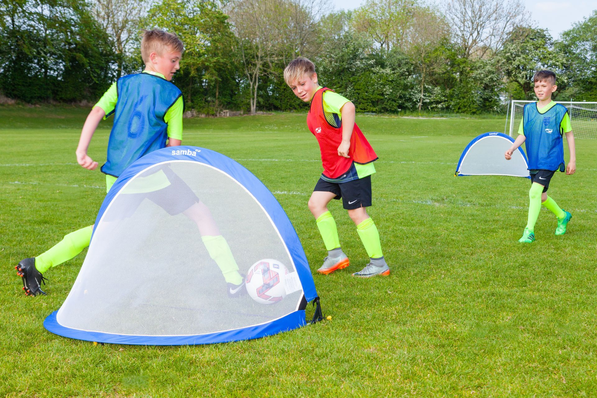 A group of young boys are playing soccer on a field