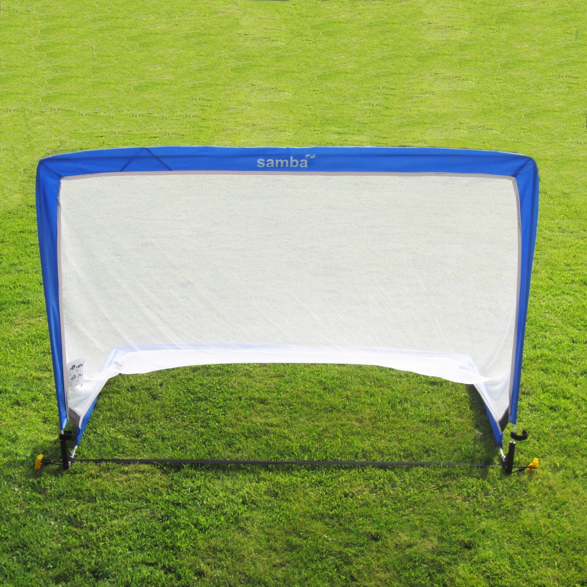 A blue and white sambu soccer goal on a lush green field